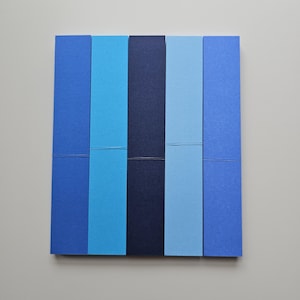May include: A square composition featuring six vertical rectangular pieces in varying shades of blue. The colors range from light to dark, creating a gradient effect. Each piece is connected by a thin, horizontal line.