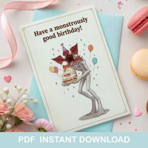 May include: Birthday card featuring a monster illustration holding a cake, balloons, and the text "Have a monstrously good birthday!". The card is on a light blue envelope with a pink ribbon and macarons in the background. The words "PDF INSTANT DOWNLOAD" are at the bottom.