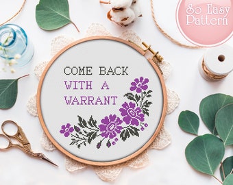 May include: Cross stitch pattern with purple flowers and the text "Come back with a warrant" on a white background.