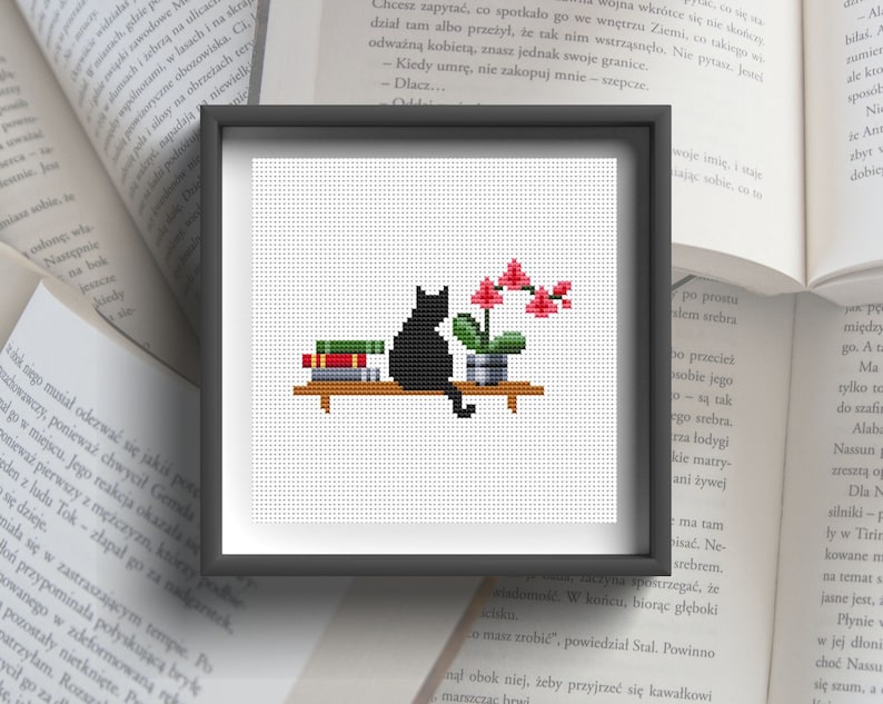 May include: A black cat sitting on a shelf with a stack of books and a potted pink orchid plant. The cat is looking at the orchid.