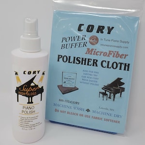 May include: A white bottle of piano polish labeled "Cory Super High Gloss Piano Polish" with a piano graphic and a blue microfiber cloth labeled "Cory Power Buffer Microfiber Polisher Cloth" with a piano graphic. The cloth is packaged in a clear plastic bag. The bottle is 8 fluid ounces and the cloth is machine washable.