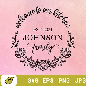 May include: Black and white welcome to our kitchen sign with a floral wreath and the text "EST. 2021 JOHNSON family".