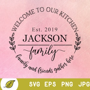 May include: Welcome to our kitchen sign with a wreath and the text "Est. 2019 JACKSON family family and friends gather here".