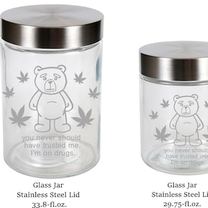May include: Two clear glass jars with stainless steel lids. Each jar features a bear illustration surrounded by marijuana leaves. Text on the jars reads, "you never should have trusted me. I'm on drugs."