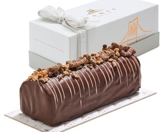 May include: A chocolate log cake topped with chopped nuts and chocolate pieces, presented in a white gift box with a ribbon. The box has the text "From Brooklyn with Love" and a logo with a bridge.