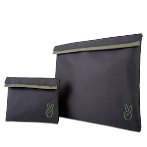 May include: Two black fabric storage bags with green peace sign logos. The smaller bag is in front of the larger bag.
