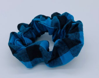 May include: A blue and black plaid scrunchie for hair.