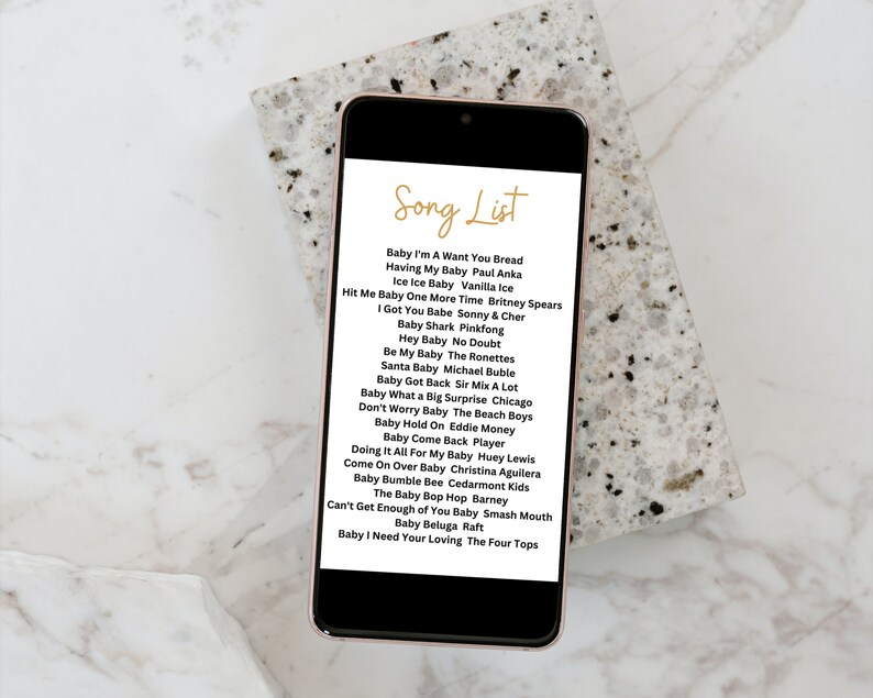 May include: A smartphone screen displaying a list of songs titled "Song List". The list includes songs about babies, such as "Baby I'm A Want You Bread", "Having My Baby", "Ice Ice Baby", "Hit Me Baby One More Time", and "I Got You Babe".