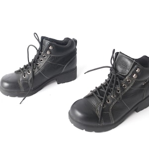 May include: A pair of black leather lace-up boots with a chunky heel.