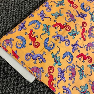 1 mtr peach multi coloured gecko lizard  print 100% cotton fabric...45” wide