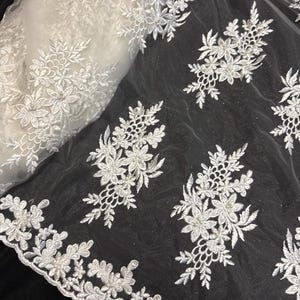 Ivory floral embroided  pearl scalloped tulle net bridal fabric..52” wide