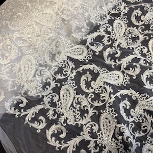 White floral paisley embroided scalloped tulle net bridal fabric..52” wide