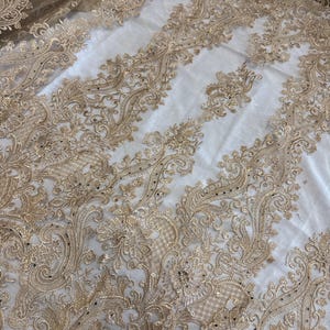 Gold floral embroided studded scalloped tulle net bridal fabric..52” wide