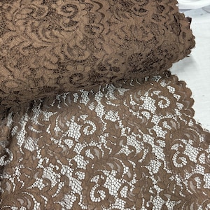 May include: Brown lace fabric with a delicate floral pattern. The lace is soft and sheer, and it would be perfect for a variety of crafting projects.