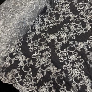 White floral embroided sequin scalloped tulle net bridal fabric..52” wide