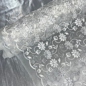 White floral embroided scalloped tulle net bridal fabric..54” wide