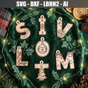 May include: A collection of seven laser-cut wooden ornaments featuring the letters S, I, V, L, M, T and a circular Christmas bauble. Each piece displays intricate engraved holiday designs including snowflakes, stars, pine branches and a tree.
