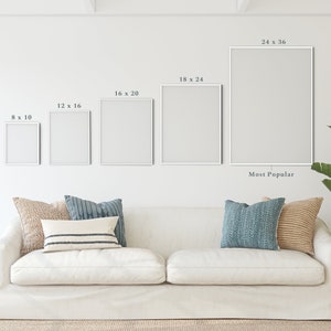 May include: A white sofa with pillows in various shades of blue and brown, a small side table with a woven basket, and a large potted plant. The wall behind the sofa has five white frames with different dimensions, labeled with their size in inches. The largest frame is labeled "24 x 36" and "Most Popular".