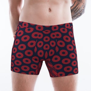 May include: Red and navy blue boxer shorts with a repeating pattern of red donuts on a navy blue background.