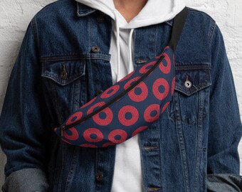May include: A person wearing a blue denim jacket and white hoodie with a red and black fanny pack with a donut pattern.
