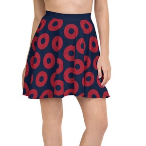 May include: A navy blue skater skirt with a red donut pattern. The skirt is knee-length and has a flared silhouette.