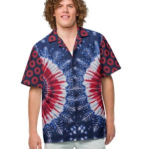 May include: A short-sleeved button-down shirt with a tie-dye pattern in red, white, and blue. The shirt is paired with light gray shorts and white sneakers. The shirt's sleeves have a repeating pattern of red circles.