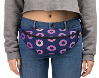 May include: A blue fanny pack with a pink donut pattern. The pack is worn around the waist of a person wearing blue jeans.
