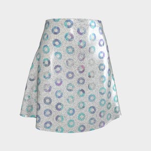 May include: A-line skirt with a silver glitter background and a pattern of colorful circles in shades of blue, purple, and teal. The skirt has a high waist and a flared silhouette, suitable for various occasions.