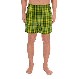 May include: Green and yellow plaid athletic shorts. The shorts have a drawstring waistband and are made of a lightweight, breathable fabric.