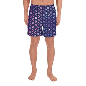 May include: Navy blue athletic shorts with a pink and purple donut pattern.