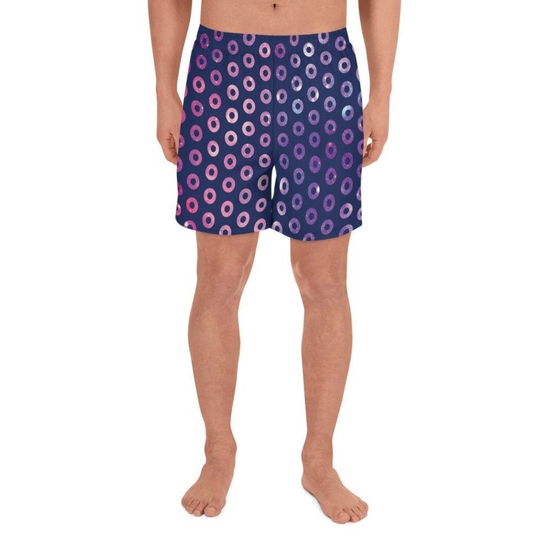 May include: Navy blue athletic shorts with a pink and purple donut pattern.