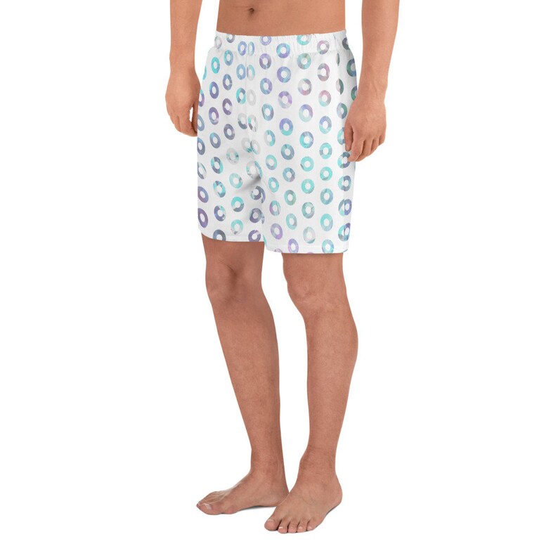 May include: White athletic shorts with a blue and purple watercolor circle pattern.