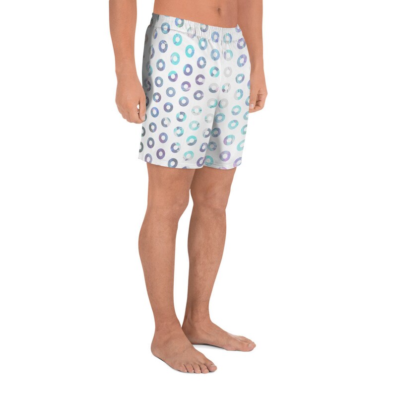 May include: White athletic shorts with a blue and purple circle pattern.
