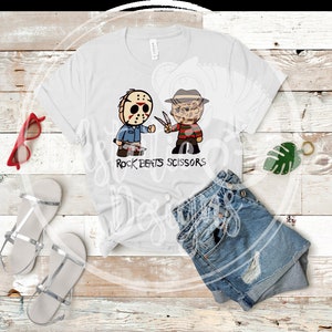 May include: White t-shirt featuring cartoon illustrations of Jason Voorhees and Freddy Krueger, with the text "Rock Beats Scissors". The shirt is paired with denim shorts, silver sandals, and red sunglasses.