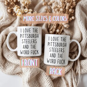 Two white ceramic mugs with black text that reads "I LOVE THE PITTSBURGH STEELERS AND THE WORD FUCK." The mugs are labeled "FRONT" and "BACK."