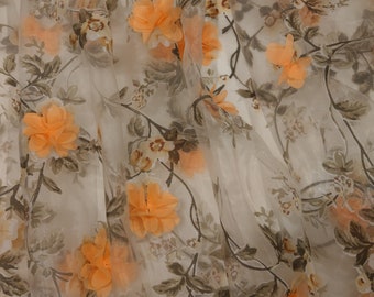 May include: A sheer white fabric with a floral pattern. The flowers are orange and brown and have a 3D effect. The fabric is translucent and has a delicate texture.