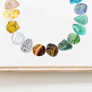 May include: A framed print of a rainbow of colorful stones arranged in a circle. The stones are various shades of green, blue, yellow, orange, and brown.