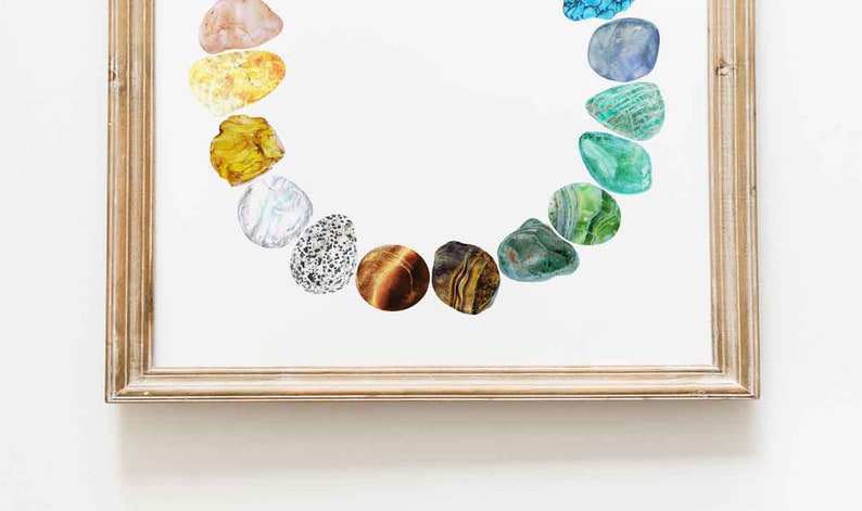 May include: A framed print of a rainbow of colorful stones arranged in a circle. The stones are various shades of green, blue, yellow, orange, and brown.
