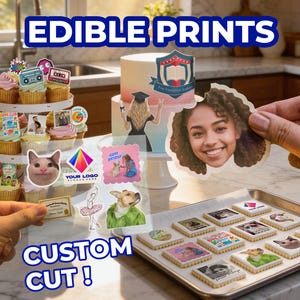 May include: A collection of edible prints featuring various custom images, including a person's face, a graduation theme, a cat, and a dog. The prints are displayed on cupcakes, a cake, and a metal baking sheet, with the text EDIBLE PRINTS and CUSTOM CUT! visible.