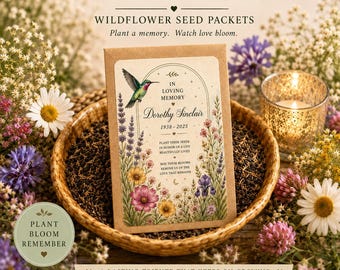 May include: A rectangular brown paper seed packet featuring a hummingbird and floral illustrations with the text In Loving Memory, Dorothy Sinclair, 1938-2025, and a memorial message. The packet sits in a brown bowl filled with dark seeds.