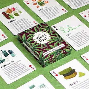 May include: A deck of playing cards titled "The Weed Deck: A Practical Guide to Cannabis" with various cannabis-related topics. The cards feature illustrations and text about topics like Sativa, CBD, and Vaporizers, set against a green background.