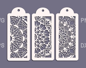 May include: Three white bookmark designs with intricate floral patterns. The bookmarks are cut out with a laser cutter and have a hole at the top for hanging.