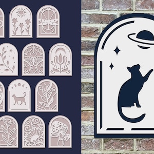 May include: A set of 14 decorative arch-shaped wall decor pieces with various designs, including flowers, butterflies, moons, stars, and a cat. The designs are cut out of the white paper and are mounted on a dark blue background. One piece features a black cat silhouette with a planet and stars.