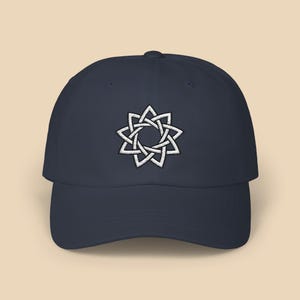 May include: A navy blue baseball cap with a white embroidered eight-pointed star design.