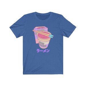 May include: A blue t-shirt with a cartoon image of a pink and purple instant ramen cup with chopsticks and a box that says "Roasted Noodle Soup" and "Ramen" in Japanese.