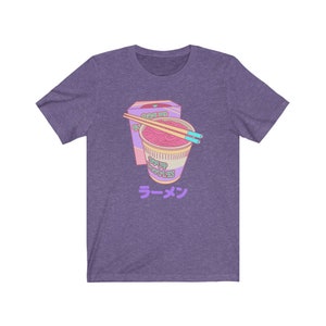 May include: Purple t-shirt with a cartoon illustration of a pink and purple instant ramen cup with chopsticks and the text "Ramen" in Japanese.
