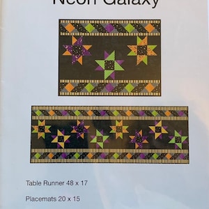May include: A quilting pattern for a table runner and placemats featuring a neon galaxy design with stars, moons, and a black background. The pattern is called "Neon Galaxy" and is designed by Jennifer Houlden, Quilts by Jen. The table runner is 48 inches by 17 inches and the placemats are 20 inches by 15 inches.