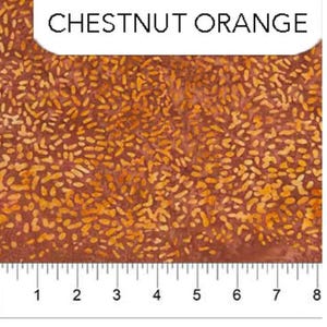 May include: A close-up of a fabric swatch with a chestnut orange color and a pattern of small, irregular shapes. The fabric is measured with a ruler in inches.