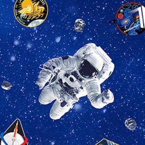May include: A repeating pattern of an astronaut in a spacesuit floating in space, surrounded by patches and asteroids. The background is a deep blue with white stars, creating a cosmic theme.