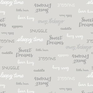 May include: A light gray background is covered with the words "Sweet Dreams", "Sleepy Time", "Snuggle", "Cuddle", "Bear Hug", and "Little Bear" in various fonts and shades of gray and white. The words are scattered across the surface.